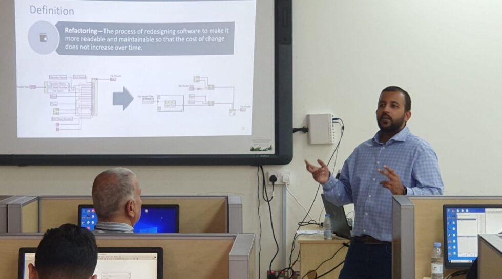 Engineer presenting a software refactoring concept in a university classroom